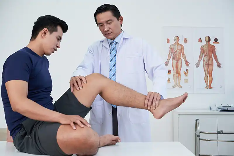 doctor performing medical clearance for surgery exam on patients knee